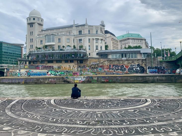 This guy was sitting at the river admiring different aspects of the city, on top we have Urania the planetarium, then we have the places where people usually go out and then the graffiti.

Who knows what the guy was thinking about? 