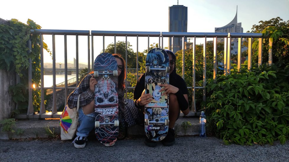 The photo captures two young girls hiding behind their skateboards. They are using them as a way to express themselves.

Even though they appear to be hiding, we can still see freedom, connection and a strong bond between them through their eyes.